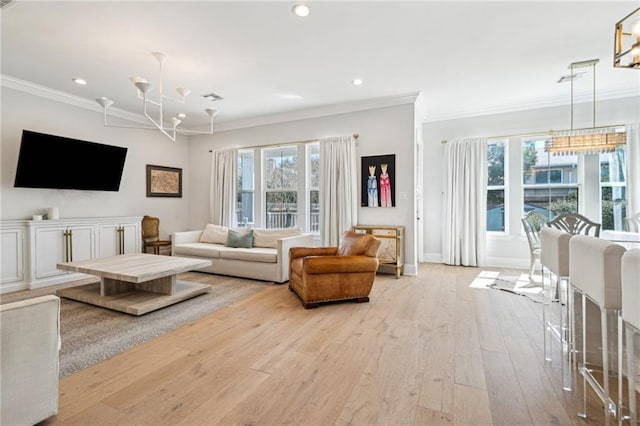 living area featuring hardwood / wood-style floors, crown molding, recessed lighting, and a wealth of natural light