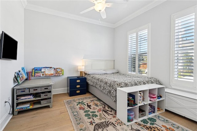 bedroom featuring ceiling fan, light wood-style floors, baseboards, and ornamental molding