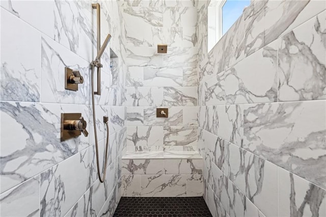 full bath featuring a tile shower