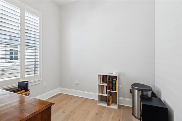 office with light wood-type flooring and baseboards