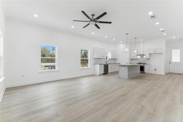 unfurnished living room with a ceiling fan, visible vents, light wood finished floors, baseboards, and recessed lighting