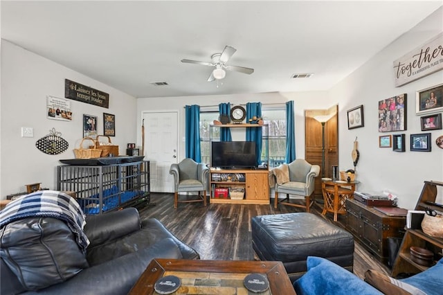 living room featuring visible vents, a ceiling fan, and wood finished floors