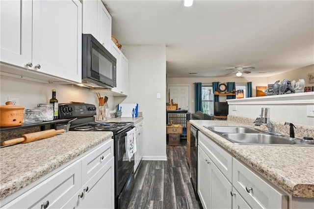 kitchen featuring a sink, black appliances, dark wood-style flooring, and light countertops