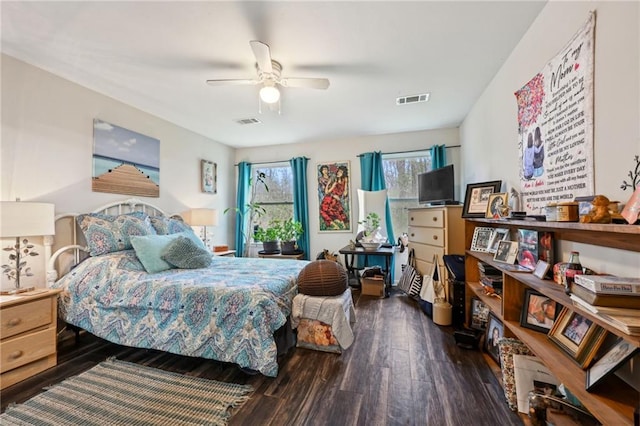 bedroom featuring wood finished floors, visible vents, and ceiling fan