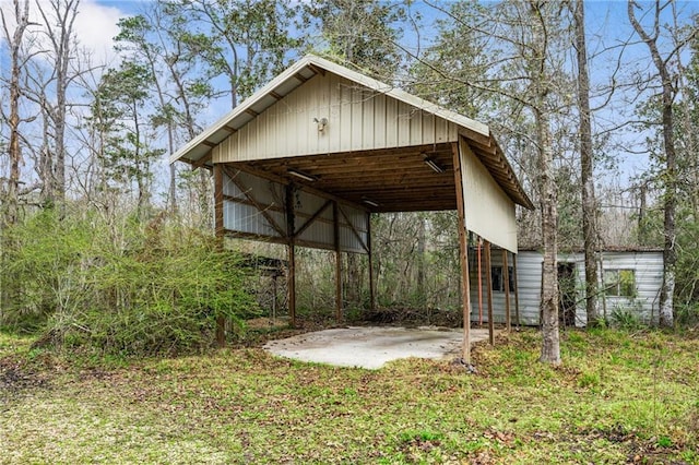 view of outbuilding featuring a carport and an outdoor structure