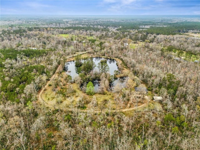 aerial view featuring a view of trees and a water view