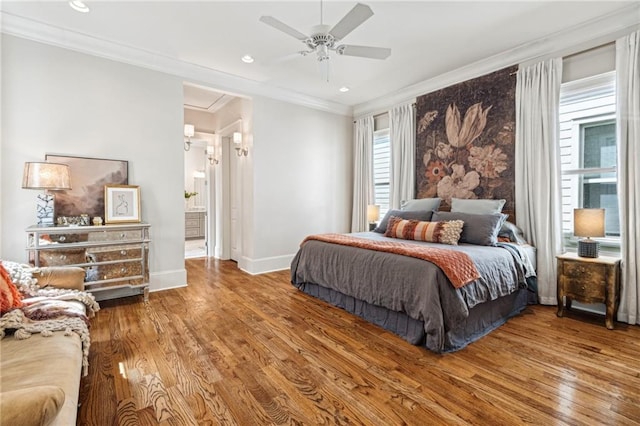 bedroom with recessed lighting, baseboards, wood finished floors, and ornamental molding