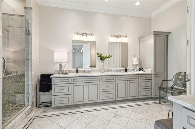 bathroom with a sink, a stall shower, ornamental molding, and double vanity