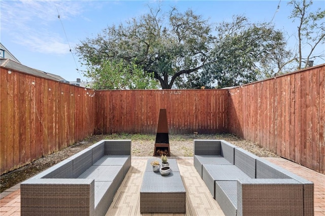 view of patio / terrace with an outdoor living space and a fenced backyard