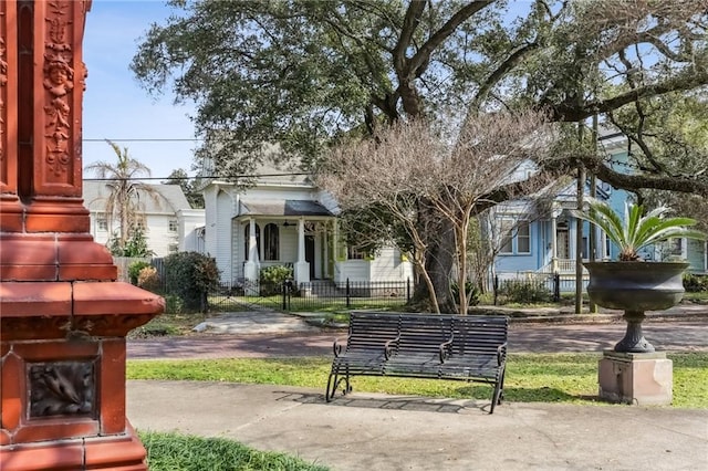 view of community with a fenced front yard