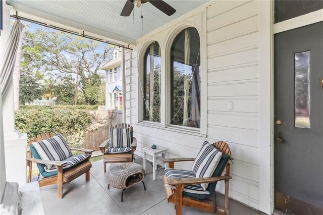 sunroom / solarium featuring ceiling fan