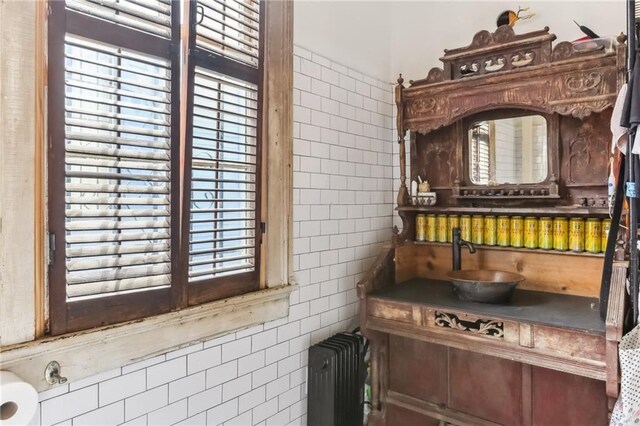 interior space featuring a healthy amount of sunlight, tile walls, and radiator heating unit