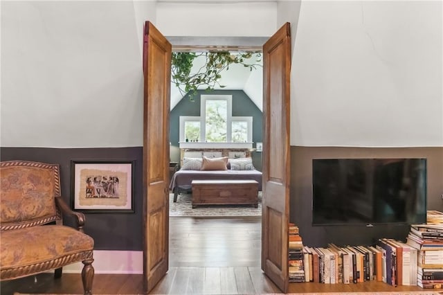 sitting room featuring vaulted ceiling and wood finished floors