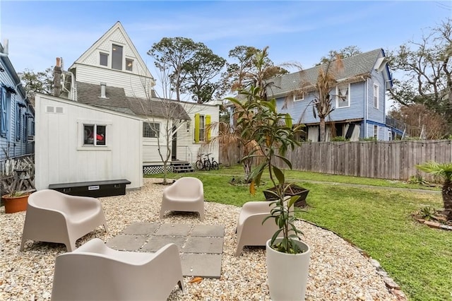 exterior space with a lawn, entry steps, and fence