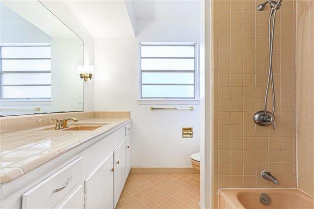 full bathroom with plenty of natural light, shower / washtub combination, toilet, and vanity