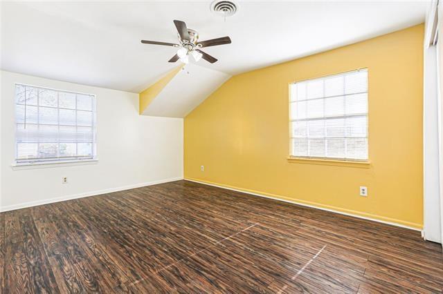 bonus room featuring vaulted ceiling, wood finished floors, visible vents, and baseboards