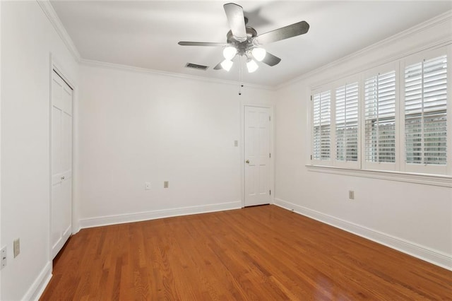 37 Spanish Fort Blvd, New Orleans, LA 70124 - spare room featuring visible vents, wood finished floors, baseboards, and ornamental molding