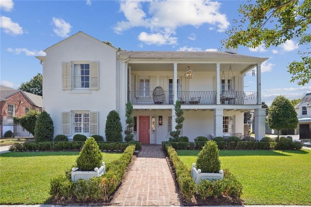 3205 Octavia St, New Orleans, LA 70125 - view of front of home featuring a balcony, a front yard, and stucco siding