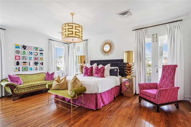 3205 Octavia St, New Orleans, LA 70125 - bedroom featuring multiple windows, access to exterior, hardwood / wood-style flooring, and crown molding