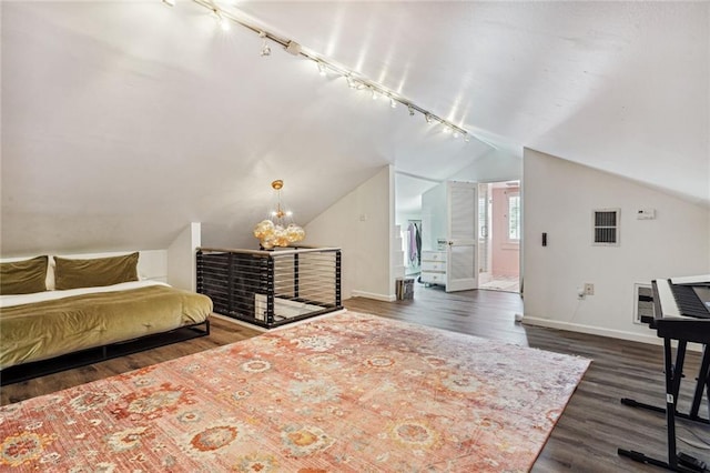 3205 Octavia St, New Orleans, LA 70125 - bedroom with rail lighting, baseboards, dark wood-style floors, and vaulted ceiling