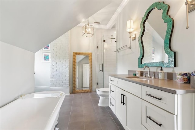 bathroom featuring tile patterned flooring, toilet, a stall shower, a freestanding tub, and vanity