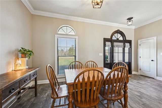 dining area with baseboards, dark wood finished floors, and ornamental molding