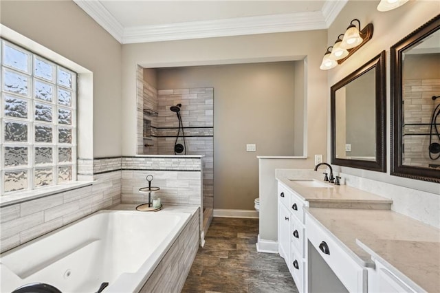 bathroom featuring vanity, crown molding, a garden tub, and a tile shower