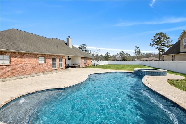 view of pool featuring a patio area, a pool with connected hot tub, and a fenced backyard