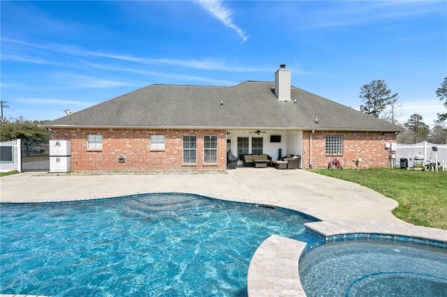 view of pool with a patio, fence, a yard, ceiling fan, and outdoor lounge area