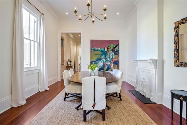 dining area featuring wood finished floors, recessed lighting, crown molding, baseboards, and a chandelier