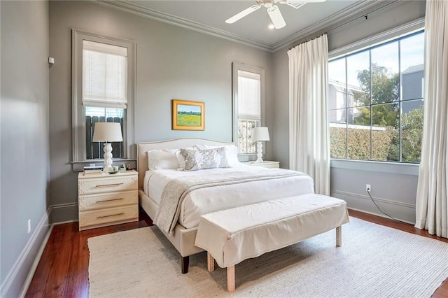 bedroom with dark wood finished floors, a ceiling fan, crown molding, and baseboards