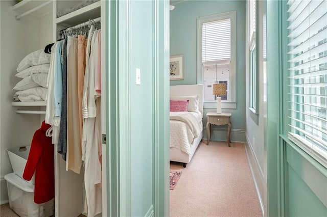 bedroom featuring baseboards and light carpet