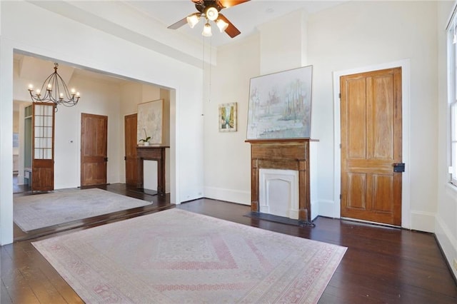 unfurnished bedroom with dark wood-style floors, a fireplace, baseboards, and an inviting chandelier