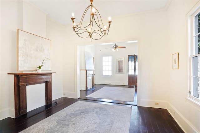 entryway featuring hardwood / wood-style flooring, baseboards, a chandelier, and ornamental molding