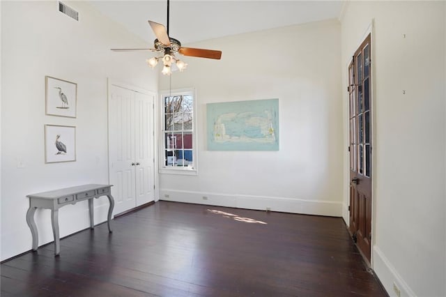 unfurnished room featuring a ceiling fan, baseboards, visible vents, and wood-type flooring