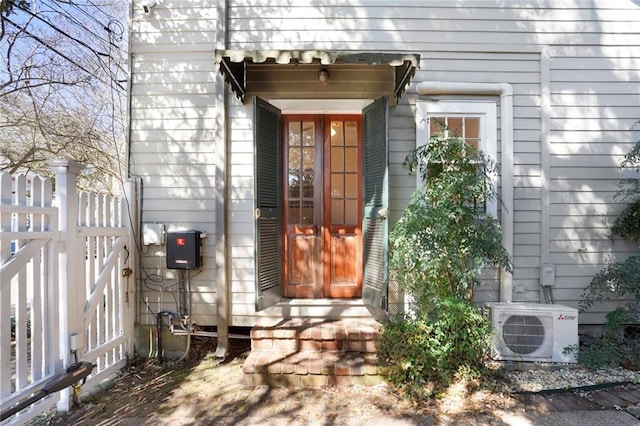 property entrance featuring a gate and ac unit