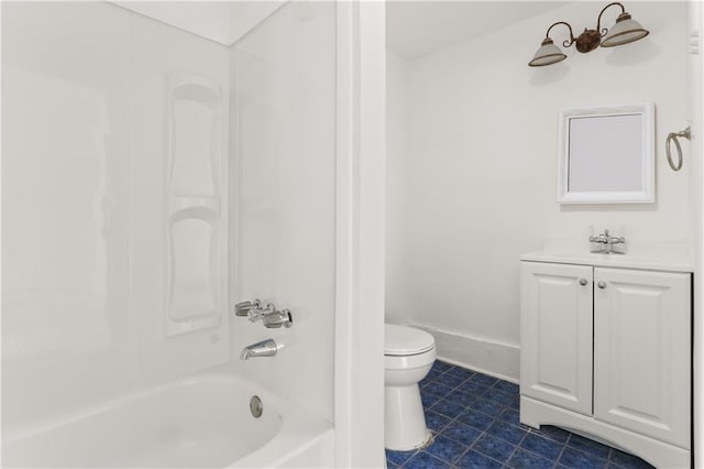 bathroom featuring toilet, vanity, tile patterned flooring, baseboards, and shower / bathtub combination