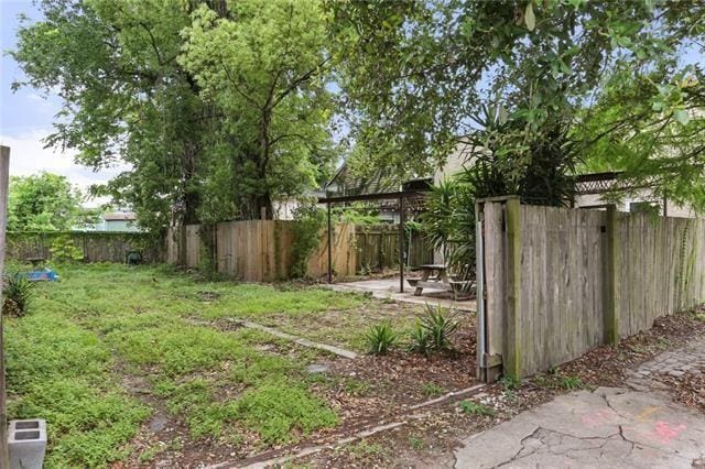 view of yard featuring a patio area and a fenced backyard