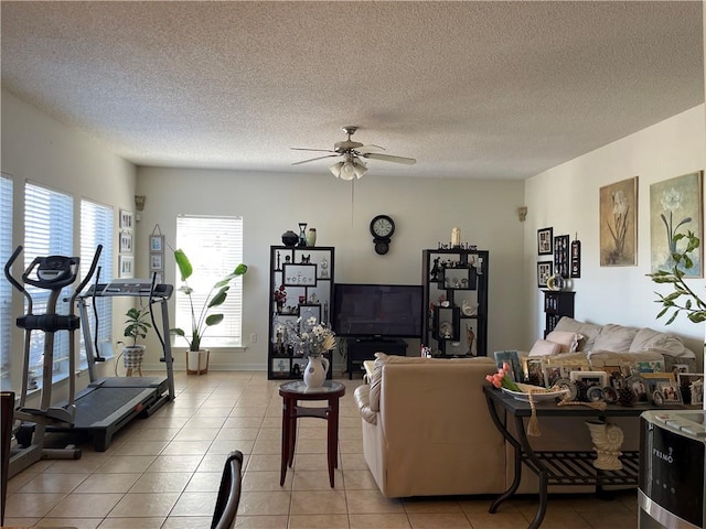 living area with light tile patterned floors, a textured ceiling, and a ceiling fan