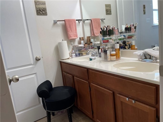 bathroom with a sink, double vanity, and tile patterned flooring