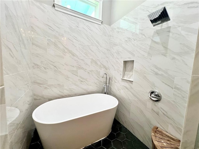 full bath with tiled shower, tile patterned floors, tile walls, and a soaking tub