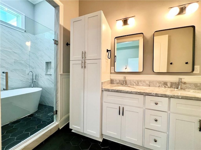 full bath with double vanity, a soaking tub, tile patterned floors, and a sink