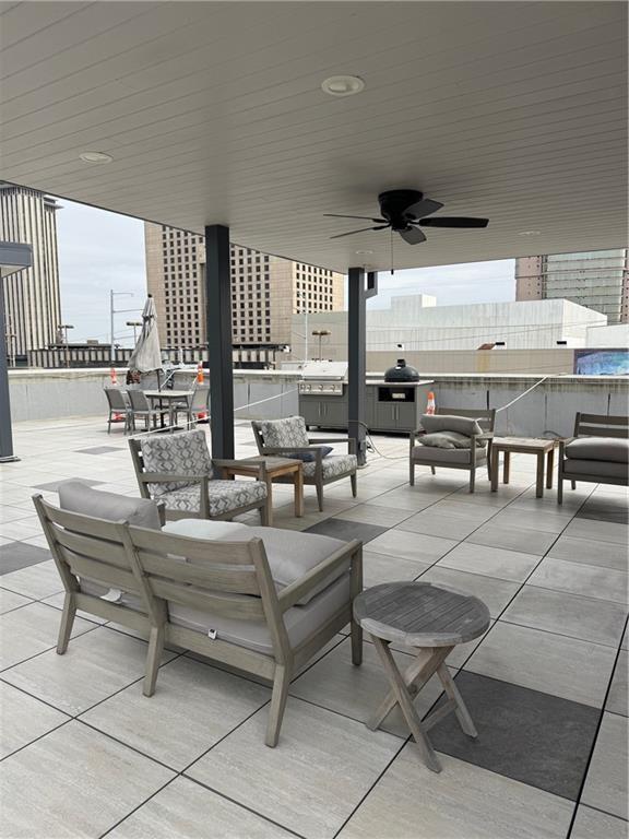 view of patio / terrace with an outdoor living space, a grill, outdoor dining area, and ceiling fan