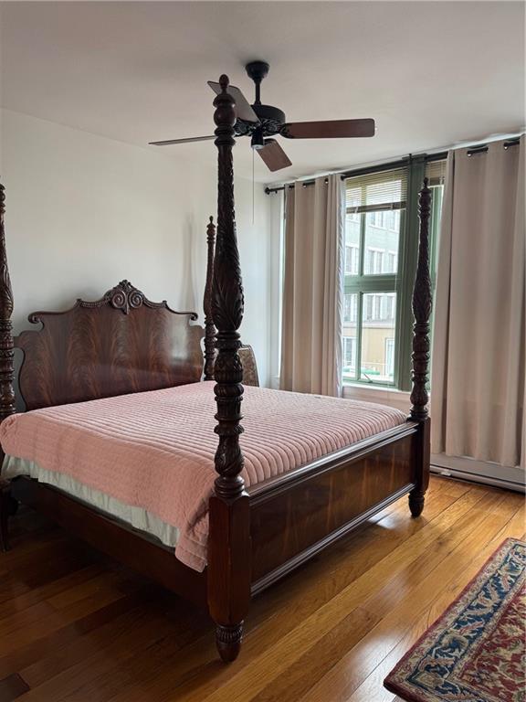 bedroom with light wood-style floors and ceiling fan