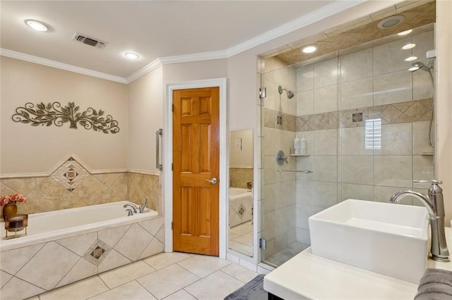 bathroom featuring visible vents, ornamental molding, a sink, a shower stall, and tile patterned flooring