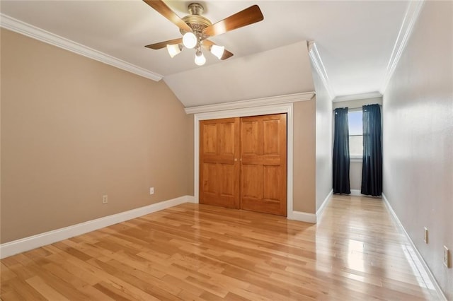 unfurnished bedroom with baseboards, crown molding, light wood-style floors, and a ceiling fan