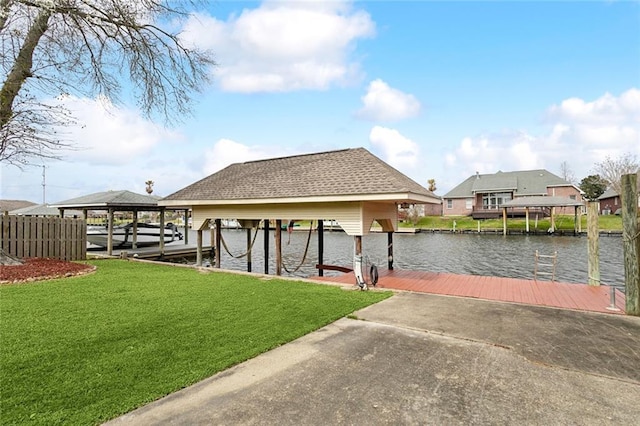 dock area featuring a water view, boat lift, and a lawn