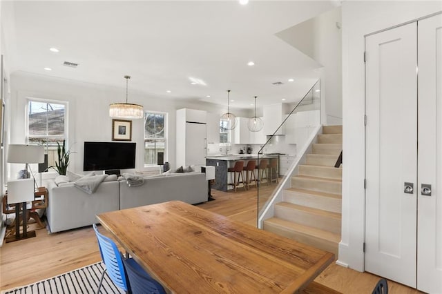 dining room featuring stairs, light wood-style flooring, recessed lighting, and visible vents