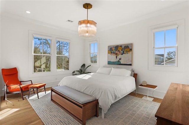 bedroom with visible vents, recessed lighting, wood finished floors, and baseboards