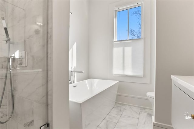 full bath with marble finish floor, a marble finish shower, baseboards, a soaking tub, and vanity